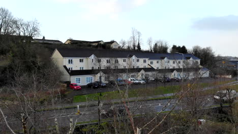 Aerial---Over-the-trees-and-bushes-nearby-the-main-road