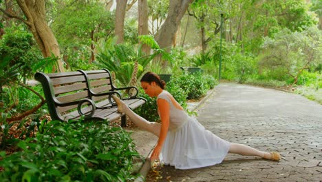 Female-ballerina-doing-stretching-exercise-in-the-park-4k