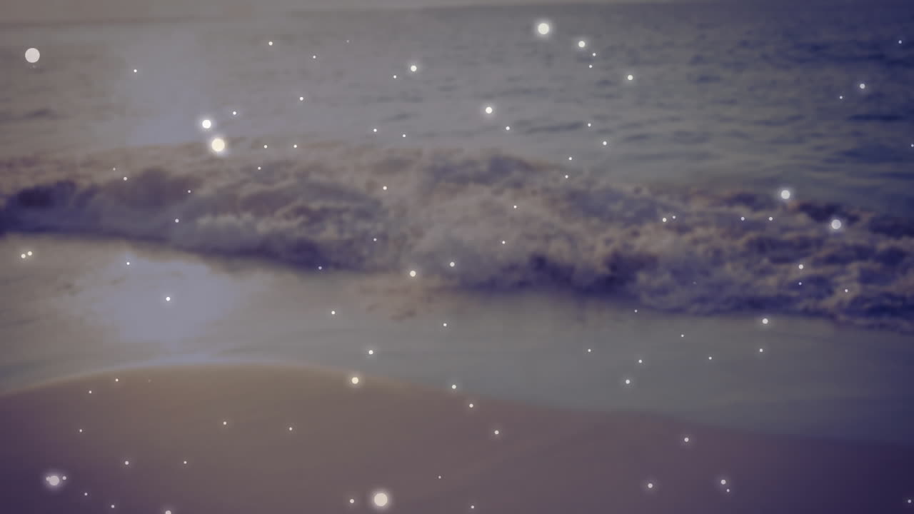 Waves gently crashing on sandy beach with sparkling light animation over water