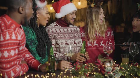 Tracking-Shot-of-Friends-Getting-Shots-at-a-Bar-During-Christmas-Celebrations