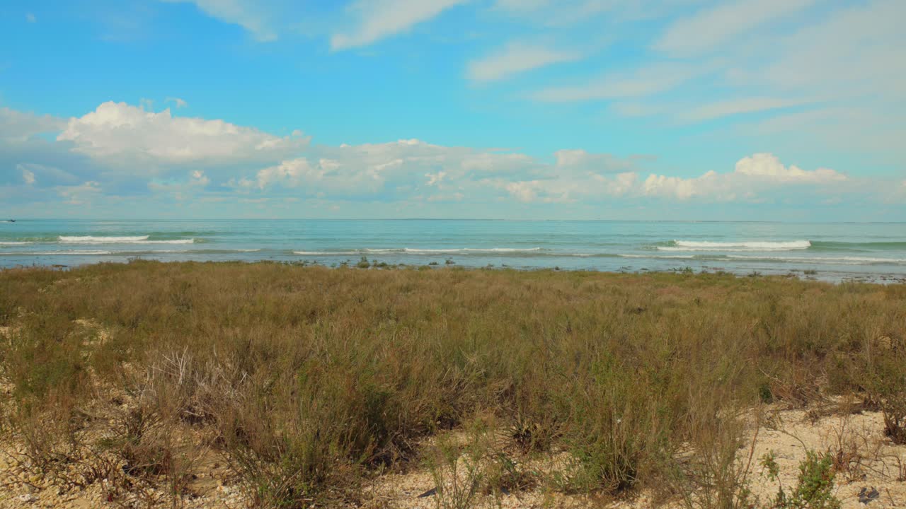 은 날 프랑스 대서양 연안의 모래 해변을 따라 부히는 파도의 사진