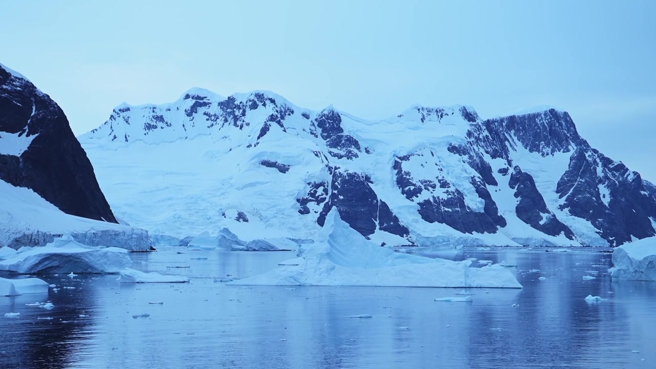 Mountains Iceberg and Winter Sea in Cold Blue Landscape Scenery, Antarctica Seascape with Ice and Glacier in Dramatic Beautiful Coastal Scene on Coast on Antarctic Peninsula, Moody Blue Atmosphric
