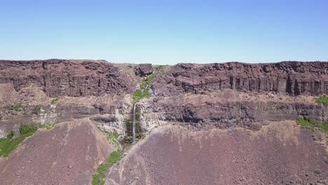 Aerial-approach-to-small-rock-canyon-waterfall-in-Frenchman-Coulee