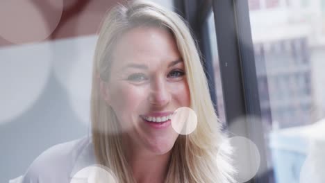 animation of spotlights over caucasian businesswoman in office