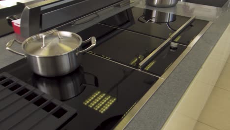 commercial kitchen cooktop with pots and pans