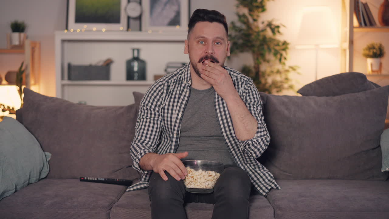 Man Watching Movie with Popcorn