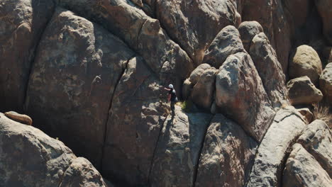 man bouldering on rocks in alabama hills on sunny day, aerial