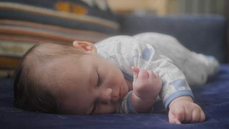 Baby-boy-laying-down-on-the-couch-on-his-side