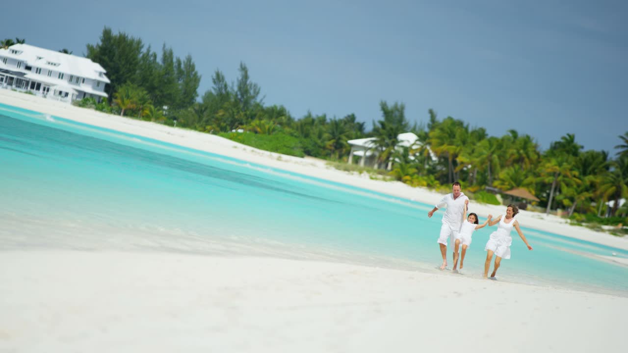 Caucasian parents and female child together on beach