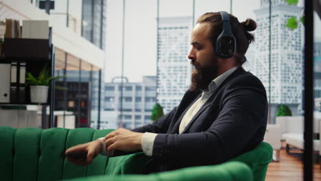 vertical video male leader relaxes during a work break using sound healing to reduce stress