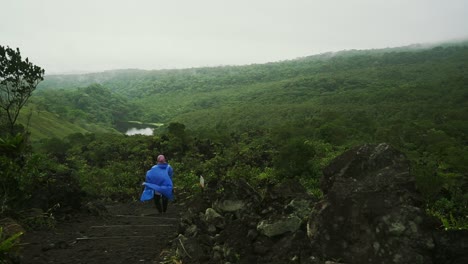 woman hikes arenal volcano trail in costa rica