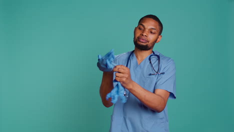 Male-nurse-putting-on-rubber-gloves,-preparing-for-surgery