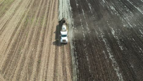 a tanker spreads liquid manure on a wisconsin farm field recently harvested of corn silage