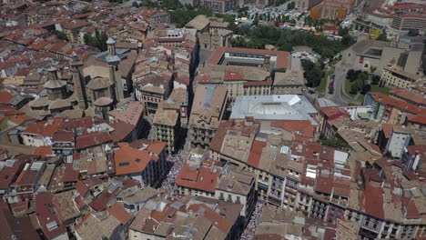 tourists gather on pamplona streets to run with bulls, spain aerial