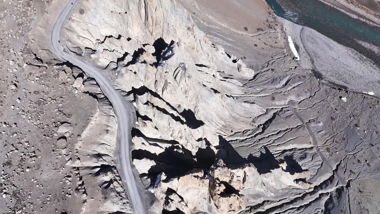 Aerial View of a Mountain Valley with Winding Road and River