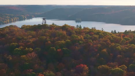 dorset lookout tower overlooks a vibrant autumn forest and lake in ontario, canada, aerial view