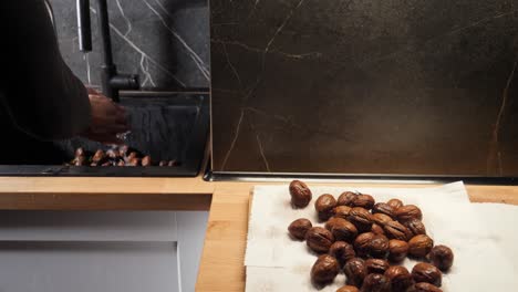 washing walnuts in sink and putting on paper towel