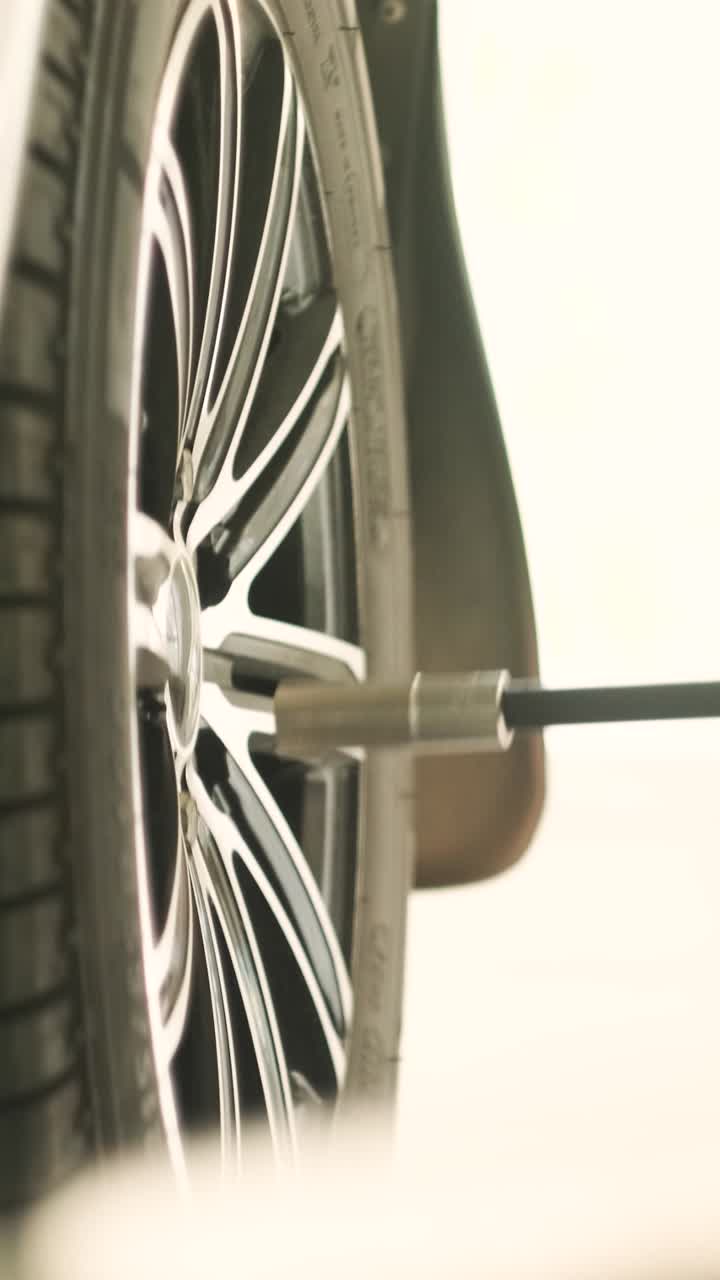Tightening Lug Nuts on a Car Wheel with a Wrench
