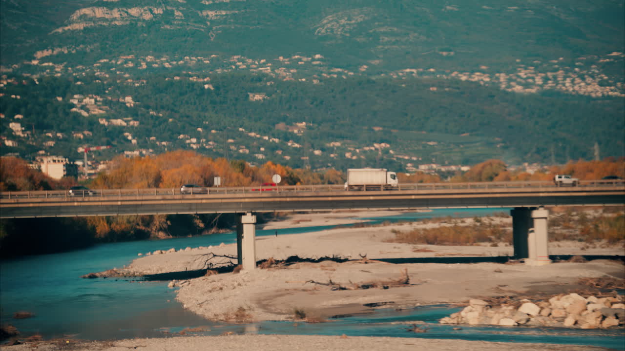 Distant view of cars moving on a bridge over the Var river in Nice, France