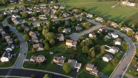 high aerial of neighborhood community residential housing development, homes along quiet winding streets in united states of america usa