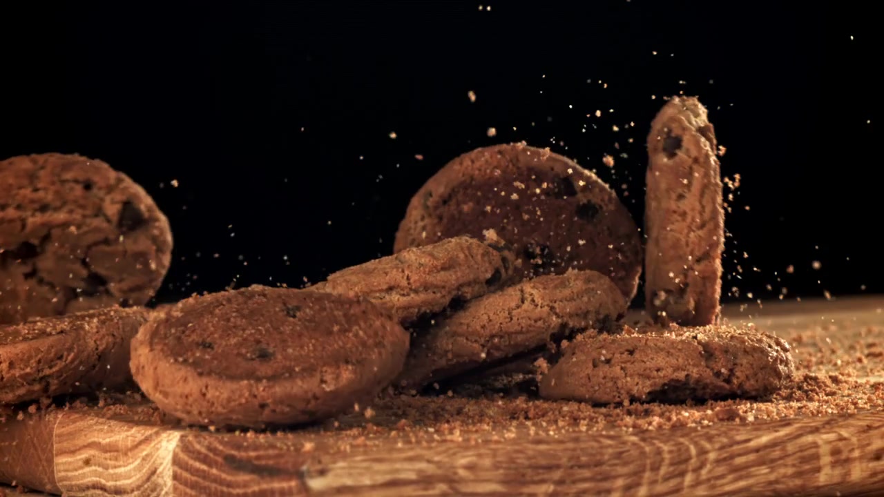 Oatmeal Cookies Falling in Slow Motion onto a Wooden Board