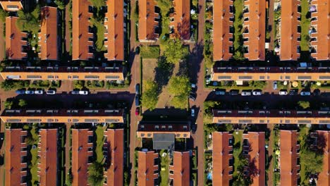 symmetric top down shot of orange roofs of residental labor neighborhood