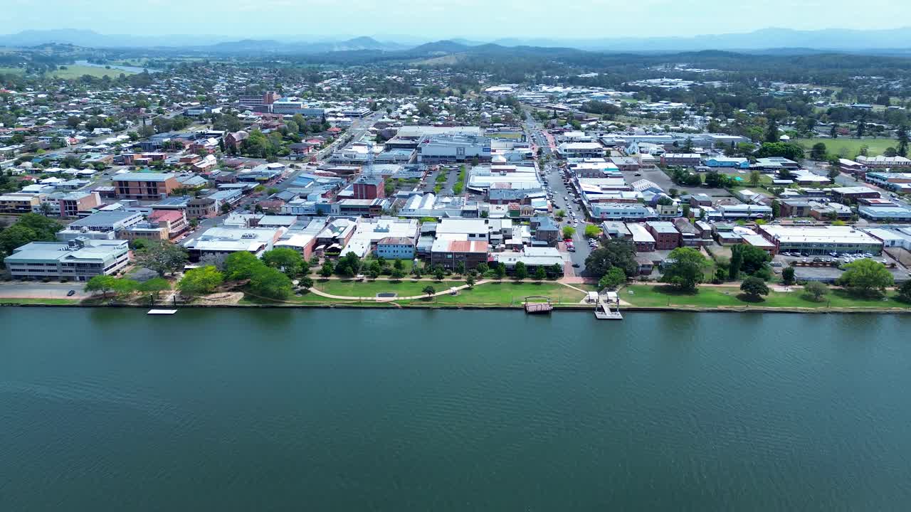 Drone aerial landscape of Taree urban downtown with waterfront foreshore boulevard park and commercial shopfronts along main road streets by Manning River in Australia travel tourism infrastructure