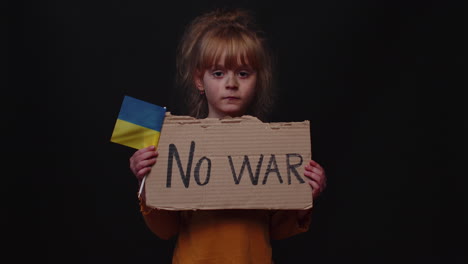 Upset-poor-toddler-child-girl-homeless-protesting-war-conflict-raises-banner-with-inscription-No-War