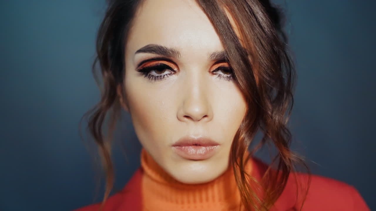 Sympathetic girl making hush gesture by forefinger. Woman smiling coquettishly