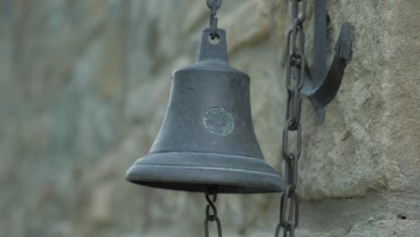 an ancient bell next to a castle