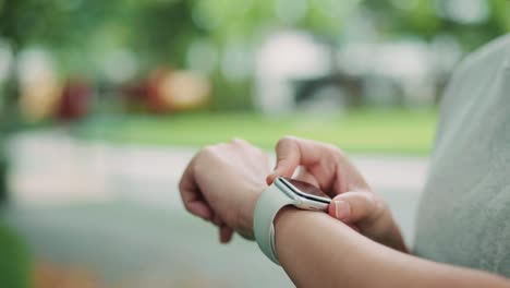woman using her smart watch touchscreen wearable technology device.
