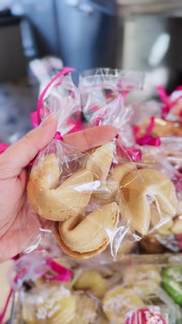 a hand holding a bag of chinese food