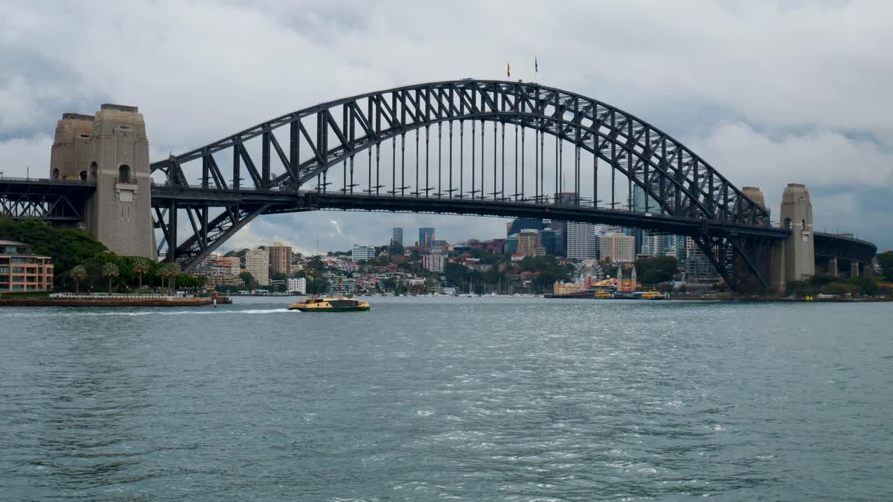 A stunning view of the Sydney Harbour Bridge with a boat passing underneath, capturing the iconic structure and the vibrant waters of the harbor.