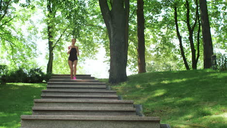 sporty woman jogging downstairs in slow motion