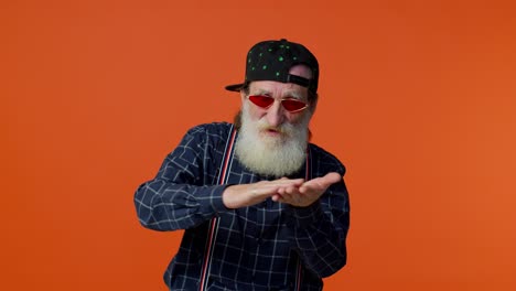 mature old bearded grandfather in sunglasses showing wasting or throwing money around hand gesture