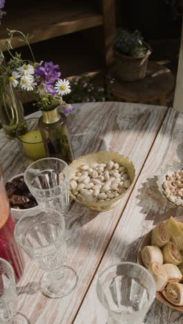 hands serving snacks on an outdoor table set for a gathering