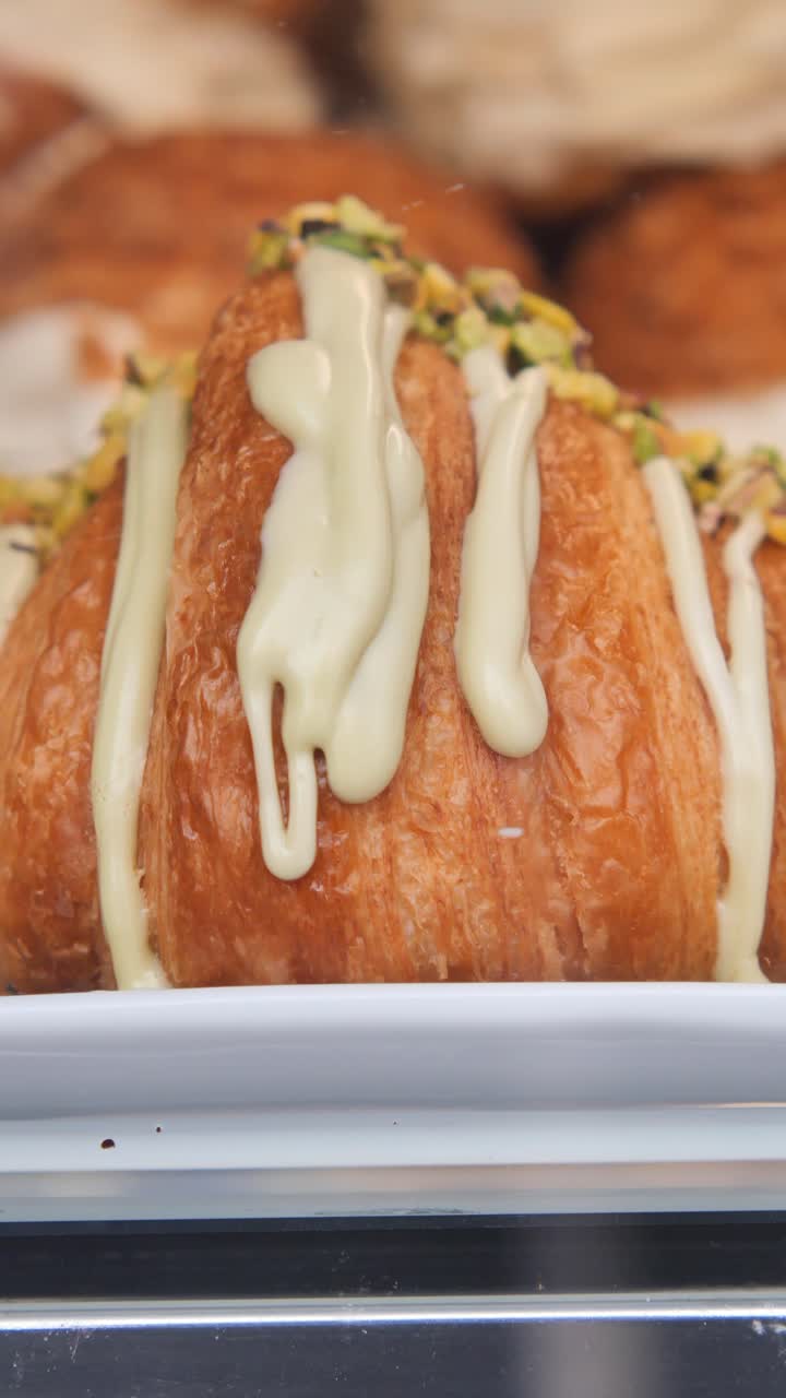 Delicious Croissant Drizzled with White Icing and Pistachios
