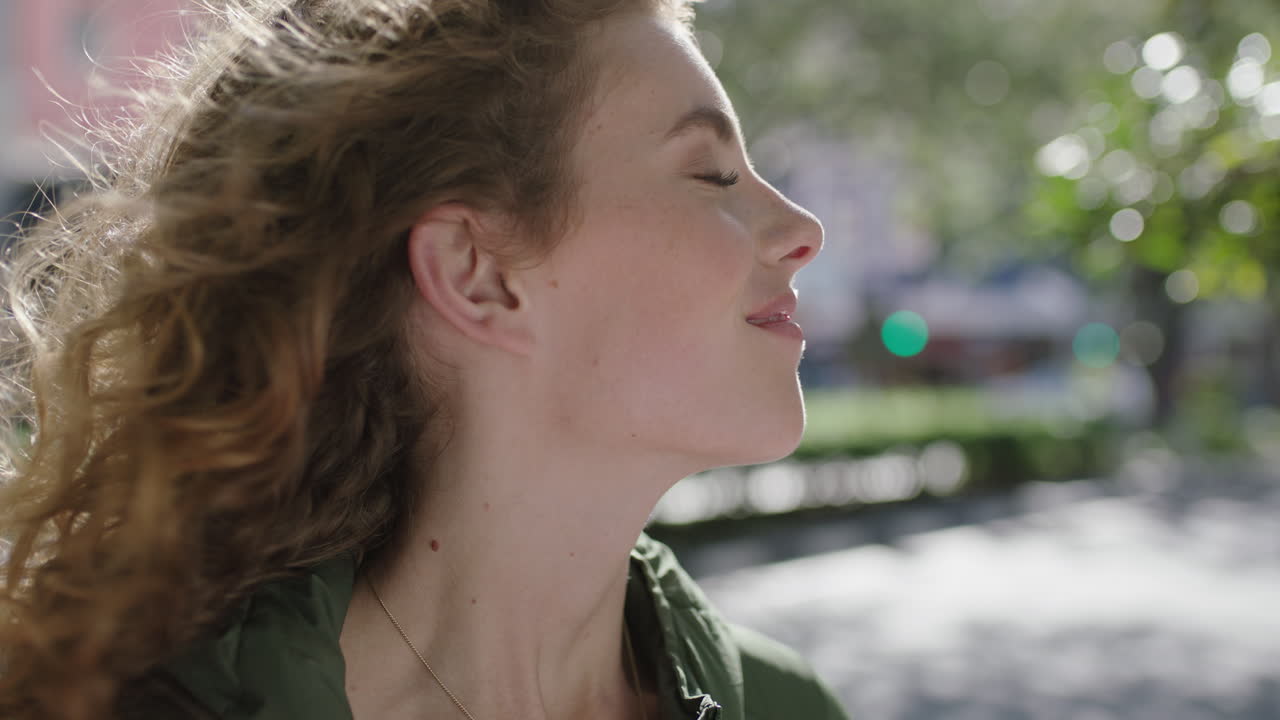 retrato en cámara lenta de una hermosa joven elegante mujer pelirroja sintiéndose relajada pacífica disfrutando del viento soplando el cabello