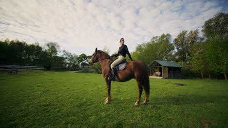 woman horseback riding in a countryside setting