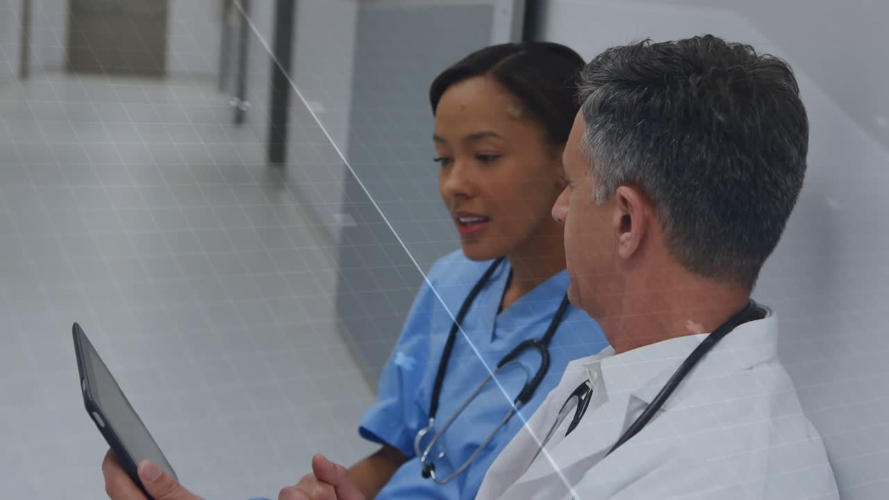 Physician angling tablet and nurse leaning in, pointing while overlay supporting clinical review