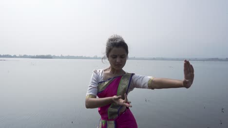 A-bharatnatyam-dancer-displaying-a-classical-bharatnatyam-pose-in-the-nature-of-Vadatalav-lake,-Pavagadh