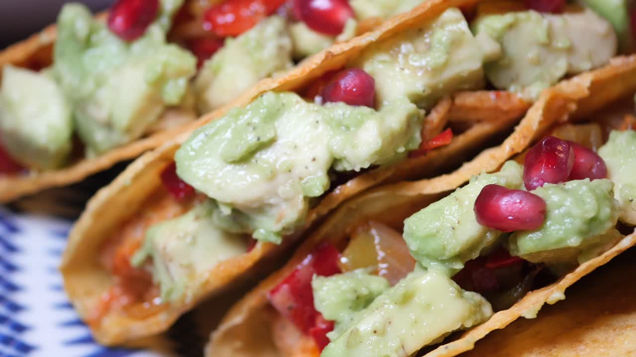 Close up of delicious Chicken Avocado Tacos with Pomegranate