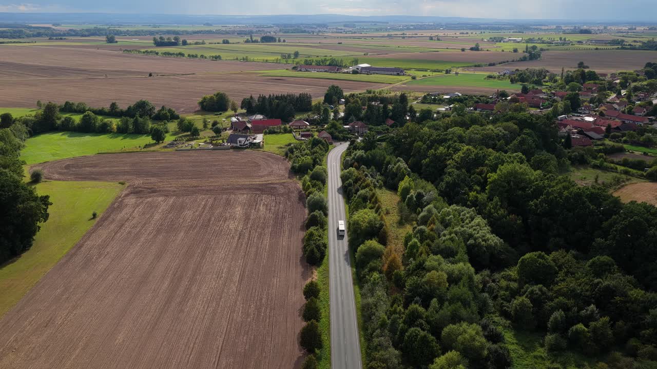 Aerial view of passing rural landscape in summer. Transport of tourists and passengers between towns of picturesque Czech countryside on a sunny day