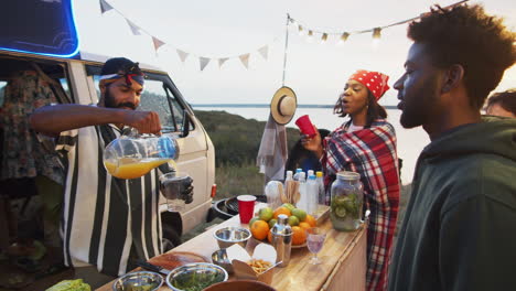 food truck seller pouring juice for customer on summer festival