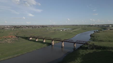 Rusty-old-decommissioned-railway-bridge-over-Vaal-River-at-Villiers,-ZA