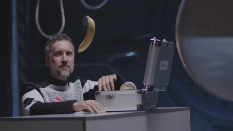 astronaut examining a banana in space