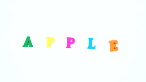 word "apple" formed of wooden multicolored letters. colorful words loop.