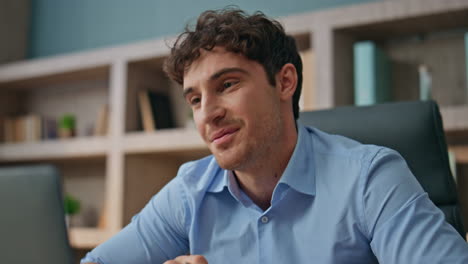 freelancer communicating web interview in office closeup. smiling man talking