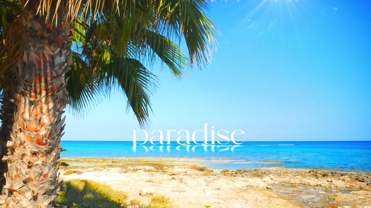 Experience PARADISE. This footage captures a stunning tropical seascape with the word reflecting on the ocean surface. Perfect visual for luxury travel promotions and aspirational lifestyle content