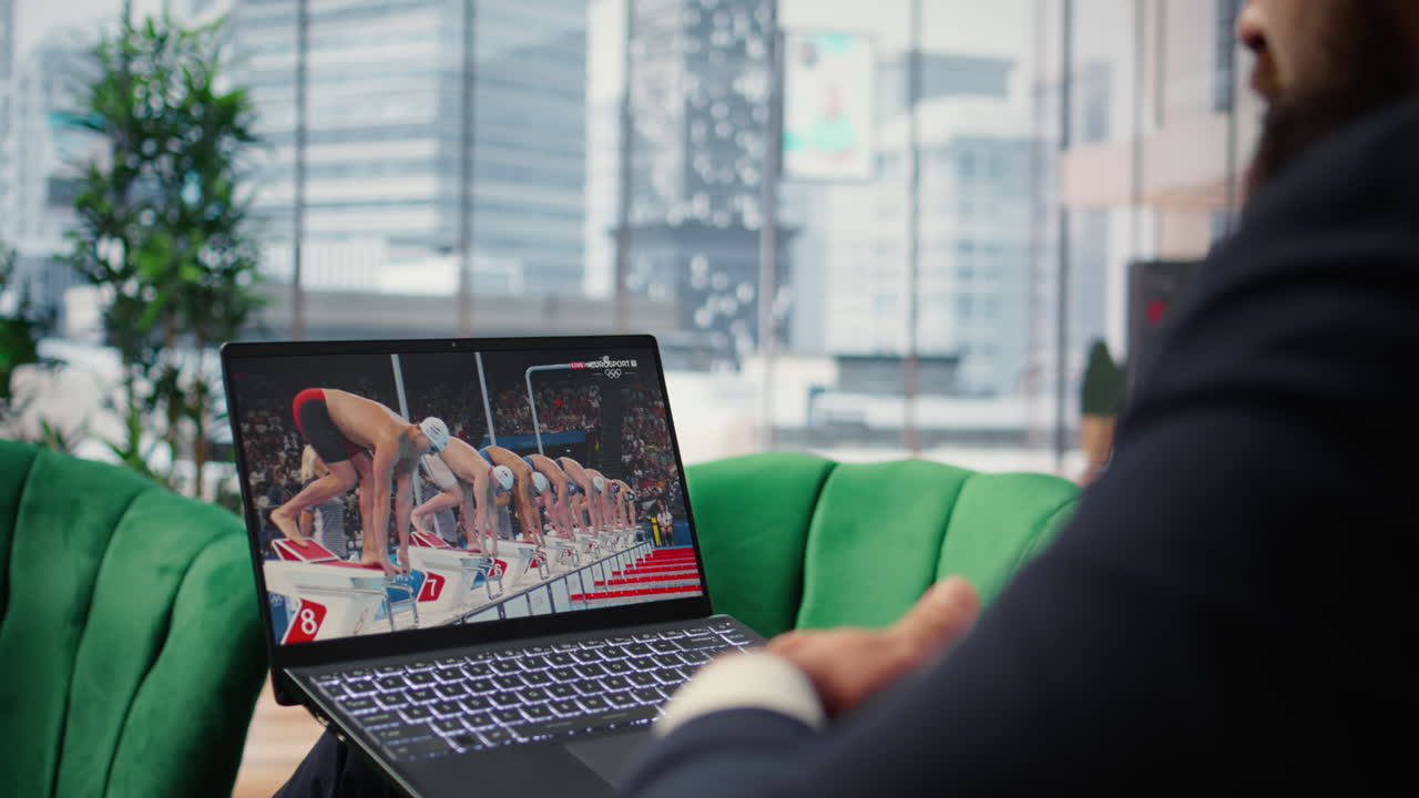 Vertical Video Bucharest, Romania - July 30th 2024 - Businessman watching Olympics live stream